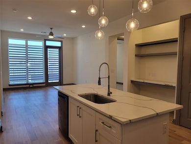Kitchen featuring a sink, a center island with sin