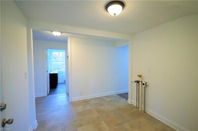 As you enter the front door, the laundry area is c