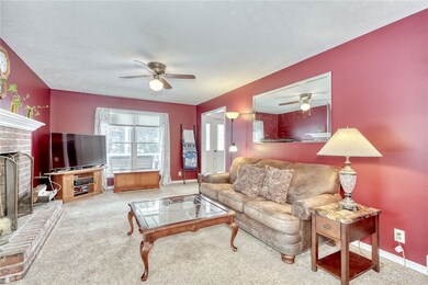 Family room with woodburning fireplace.