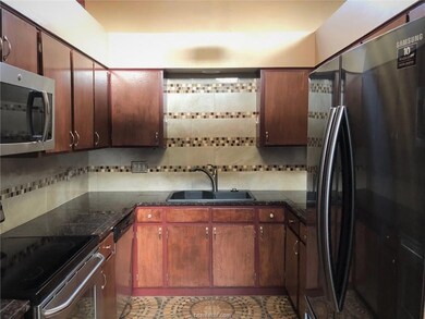 Kitchen with stainless steel appliances, a sink, d