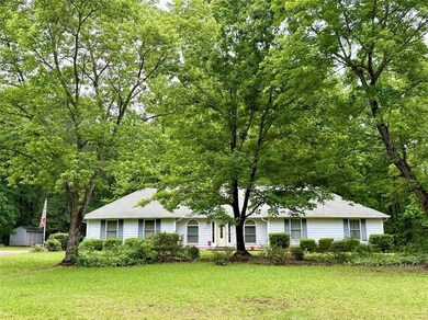 Ranch-style house with a front lawn, a storage uni