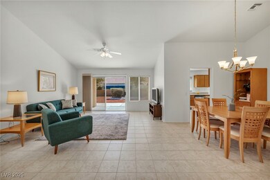 Living area with vaulted ceiling, light tile patte