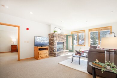 The living room features ski slope mountain views