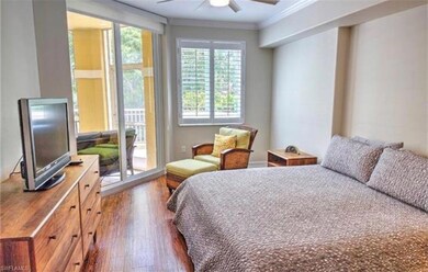 Bedroom featuring dark wood finished floors, crown molding, access to exterior, and a ceiling fan