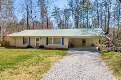 Ranch-style house with a front lawn, driveway, an 