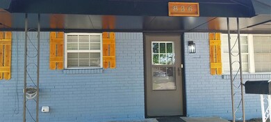 View of exterior entry with brick siding