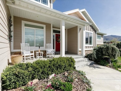 View of exterior entry with a porch and stone siding