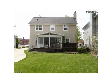 Rear elevation of home shows deck and sunny 3-seas