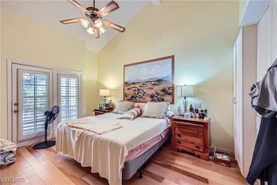 Bedroom featuring access to outside, light wood fi