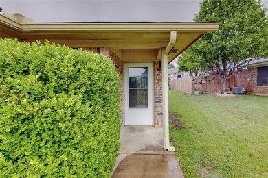 Entrance to property featuring a yard and central air condition unit