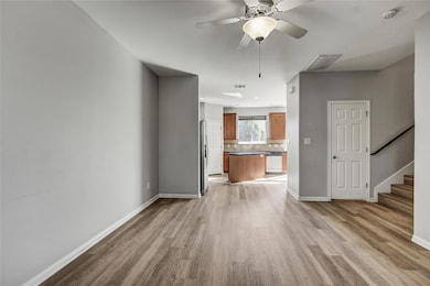 Unfurnished living room with light wood-type floo