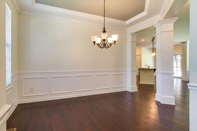 A trey ceiling highlights this open dining space