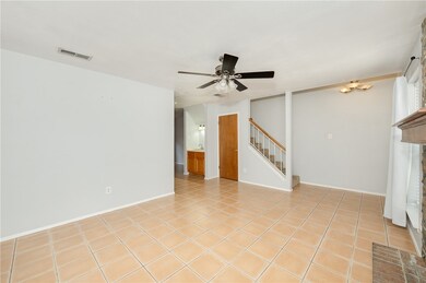 Unfurnished living room featuring stairway, a ceil