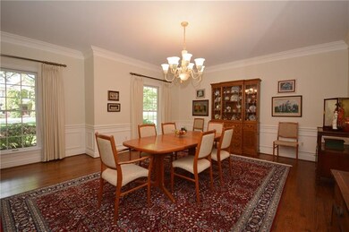 Gather in the large dining room with traditional m