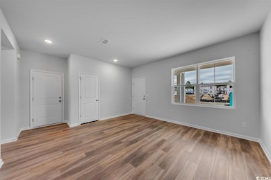 Empty room with baseboards, visible vents, recesse
