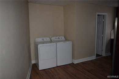 Washroom featuring washer and clothes dryer, dark