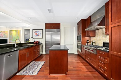 Kitchen featuring built in appliances, a sink, ba