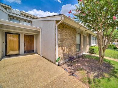 Doorway to property featuring a patio area