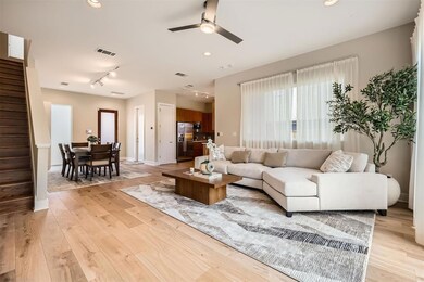 Living room with stairs, track lighting, a ceilin