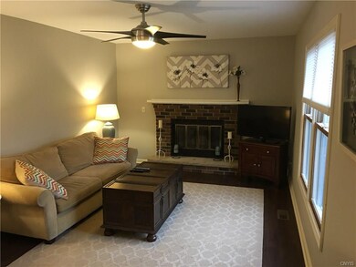Homey, bright family room with wood burning fireplace.