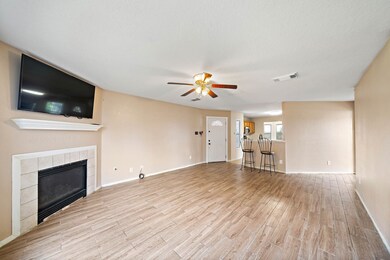 Come take a tour....Front entry overview facing kitchen. Living room fireplace and mantle ready to host. Tile has been upgraded throughout the first floor.
