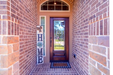 Front porch is nicely tucked back for extra privacy and has a beautiful front door.