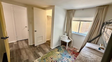 Sitting room with dark wood-style floors and baseboards