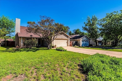 Ranch-style home with a front yard, stone siding,