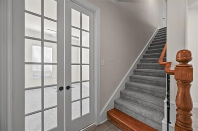 Stairs with french doors and hardwood / wood-style