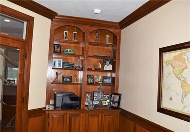 Den has built-in bookcase with lower cabinet.