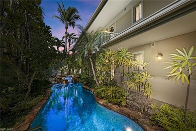 Pool at dusk featuring a pool with connected hot tub