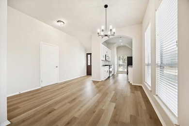 The living and dining areas filled with natural light blend beautifully, creating a warm, connected space where family and friends can gather.