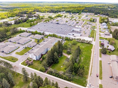 Aerial view of property's location featuring a forest