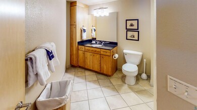 Bathroom with tile patterned floors, toilet, and v