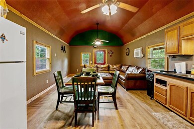 Dining area featuring ceiling fan, vaulted ceiling