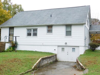 Unfinished basement runs full length of home.