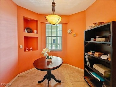 Dining room with light tile patterned flooring, built in shelves, and a textured ceiling