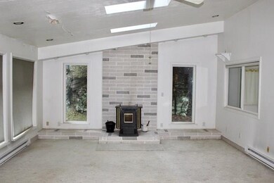 Family room with vaulted ceilings, skylights and p