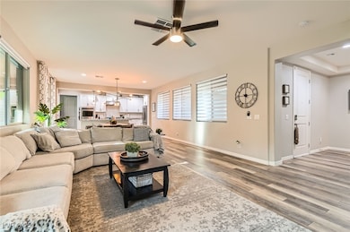 Living area with light wood-style flooring, a ceil