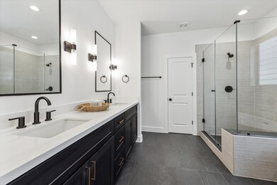Ensuite bathroom complete with dual vanities, quar