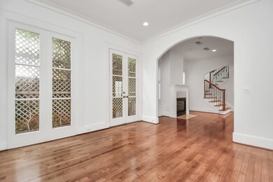 Striking formal dining room with gleaming wood flo