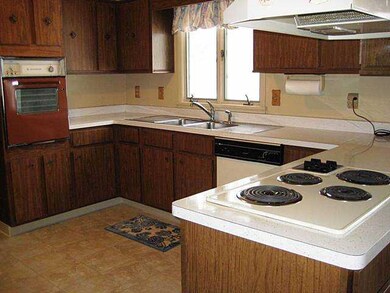 Kitchen. The overiszed kitchen has ample cabinet s