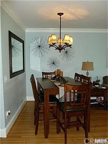 dining area with wood floors & chandelier