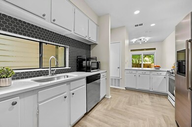 Kitchen with stainless steel appliances, light co