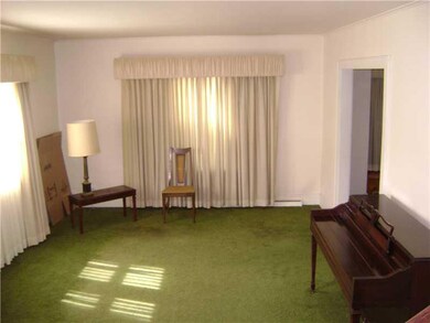 Living Room. Features hardwood floors under carpet