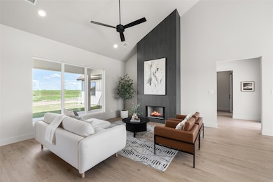 Living area with high vaulted ceiling, ceiling fa