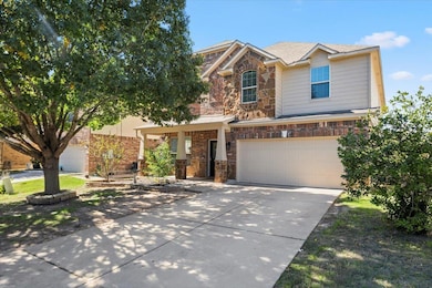 View of front of home with stone siding, concrete