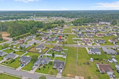 Aerial overview of property's location featuring nearby suburban area