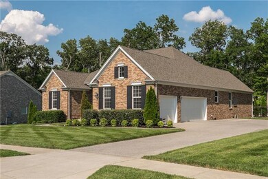 Large 3 car side entry garage with 20 feet of added aggregate driveway for ample parking.