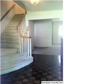 Foyer with parquet flooring, sweeping staircase, a